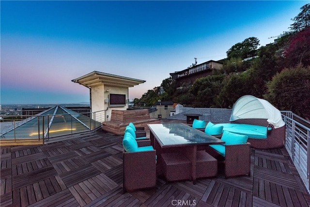 patio terrace at dusk featuring an outdoor hangout area