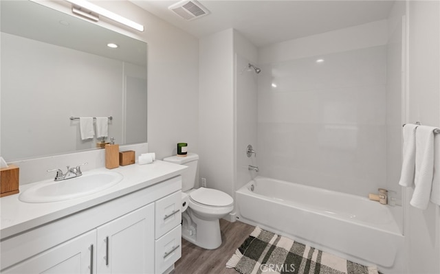 full bathroom featuring bathtub / shower combination, vanity, wood-type flooring, and toilet