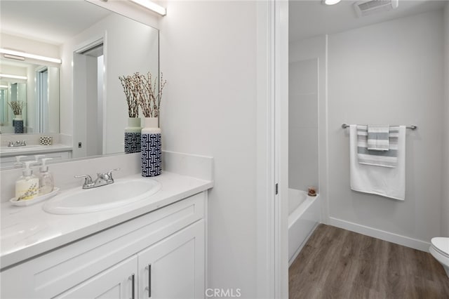 full bathroom featuring vanity, separate shower and tub, hardwood / wood-style flooring, and toilet