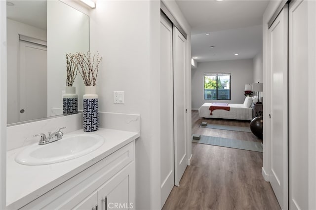 bathroom with vanity and hardwood / wood-style floors