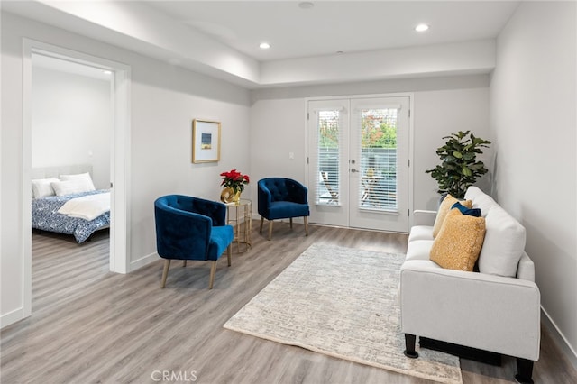 living area with french doors and light wood-type flooring