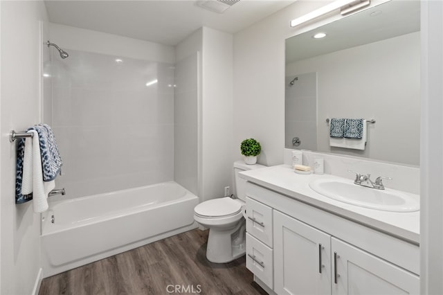 full bathroom featuring tiled shower / bath, vanity, and toilet