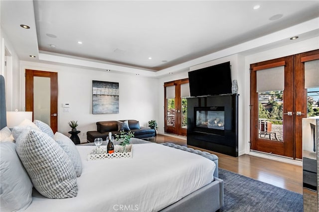 bedroom featuring access to exterior, french doors, and multiple windows