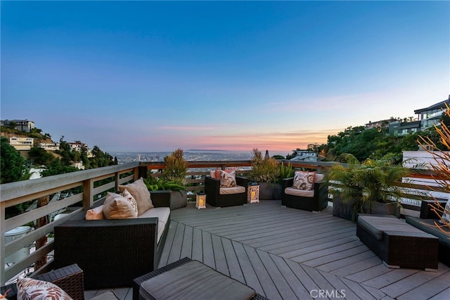 deck at dusk with an outdoor hangout area