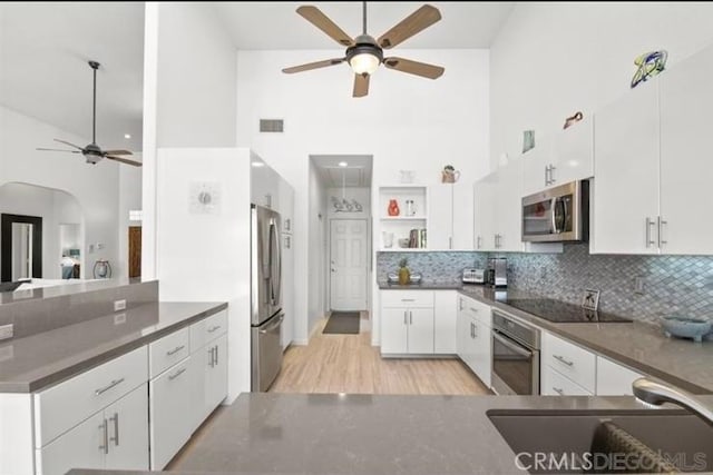 kitchen featuring stainless steel appliances, white cabinetry, and sink