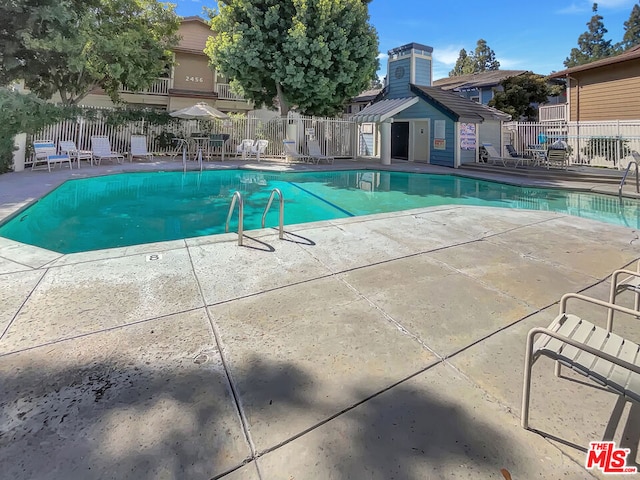 view of pool with an outdoor structure and a patio area