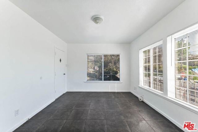 spare room featuring plenty of natural light