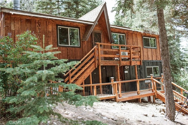 snow covered house with a deck