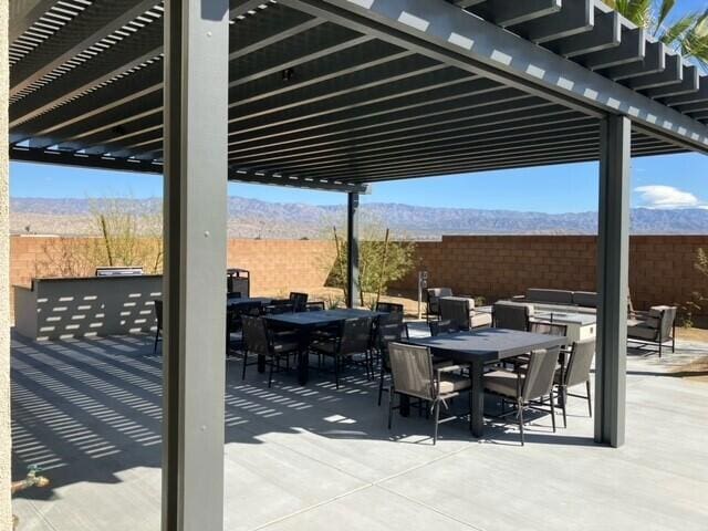 view of patio / terrace featuring a pergola and a mountain view