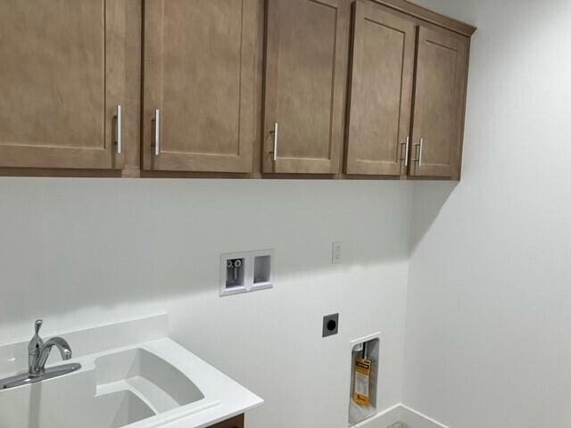 laundry room featuring cabinets, electric dryer hookup, washer hookup, and sink