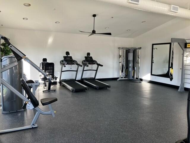 gym with lofted ceiling and ceiling fan