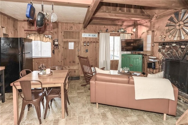 living room featuring beam ceiling and wood walls