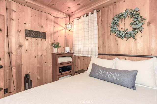 bedroom with wood ceiling and wooden walls