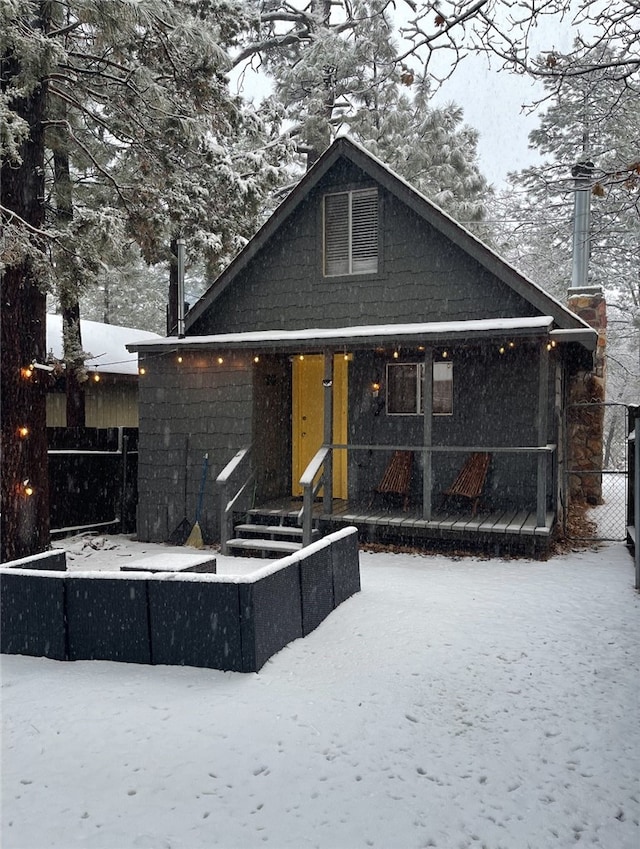 view of snow covered rear of property