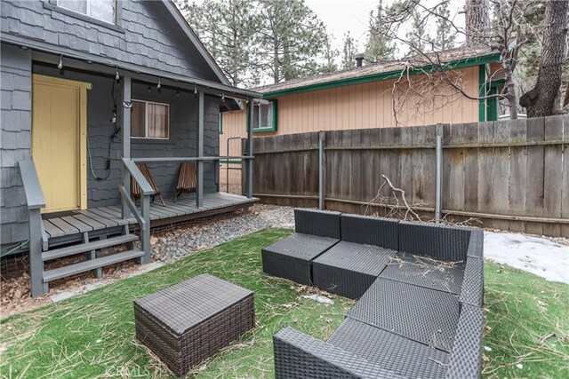 view of yard with an outdoor living space and a deck