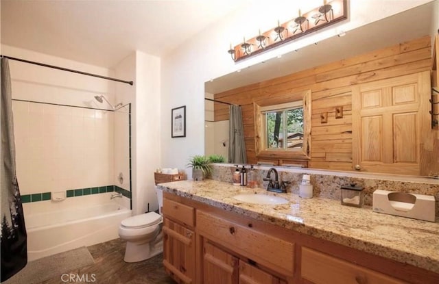 full bath featuring vanity, shower / bath combination with curtain, and toilet