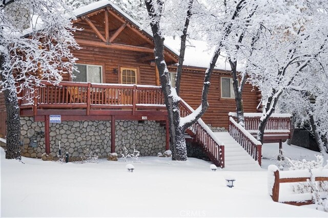 view of front of property featuring stairs and a wooden deck