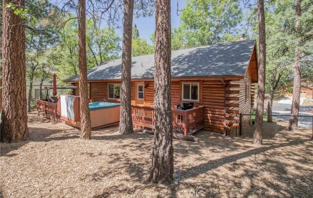 back of house with a wooden deck