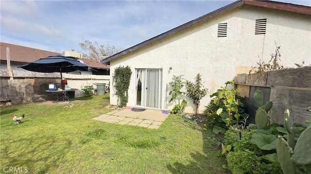 rear view of property featuring a lawn