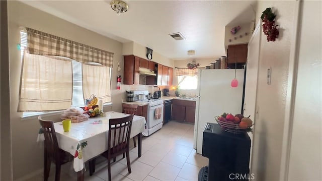 kitchen featuring white appliances and light tile patterned floors