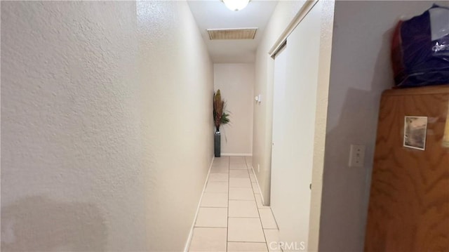 hall with light tile patterned flooring