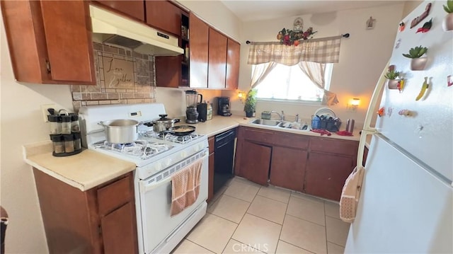 kitchen with light tile patterned flooring, sink, and white appliances