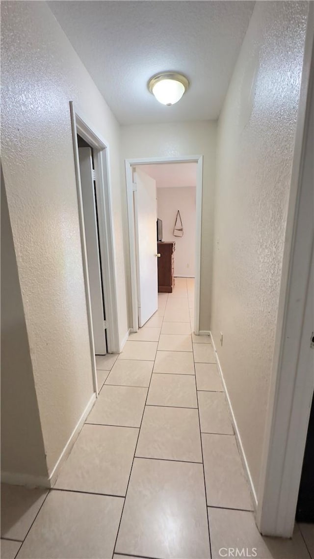 corridor with light tile patterned floors