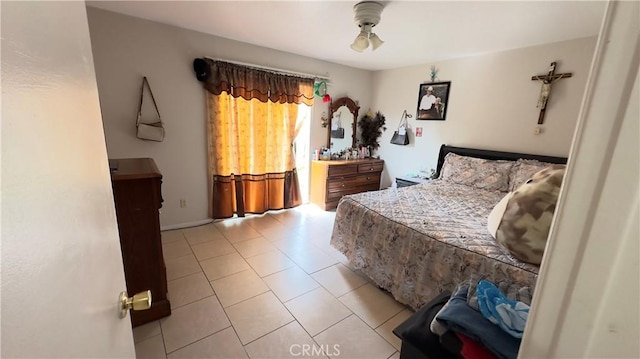 tiled bedroom featuring ceiling fan