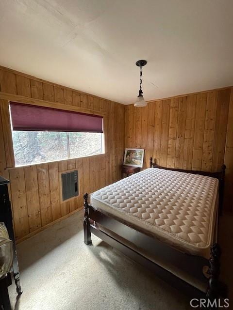 carpeted bedroom featuring wooden walls