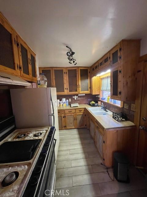 kitchen with electric range oven and sink