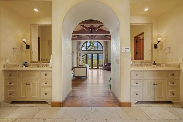 bathroom with french doors and vanity