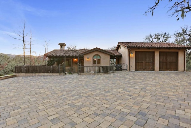 mediterranean / spanish house with a garage