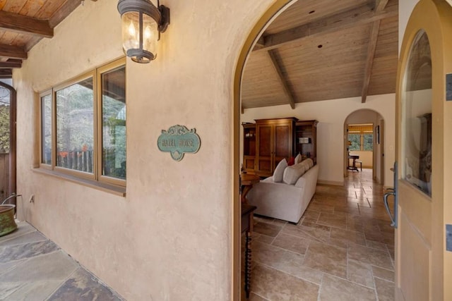 interior space with vaulted ceiling with beams and wood ceiling