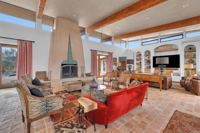 living room featuring built in shelves and beam ceiling