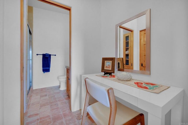 bathroom featuring vanity, toilet, and a shower with shower door