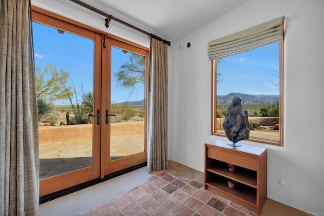 doorway to outside featuring a wealth of natural light, a mountain view, and french doors