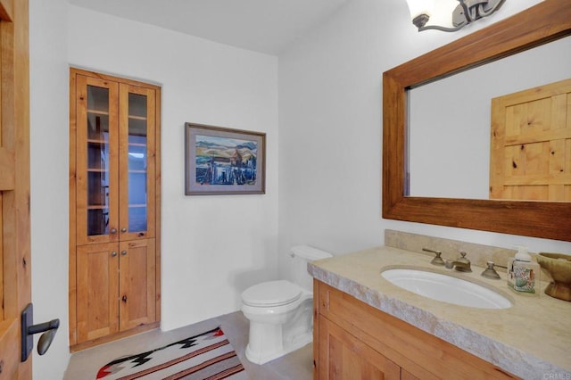 bathroom with tile patterned floors, vanity, and toilet