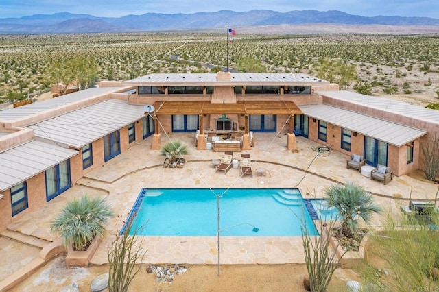 view of swimming pool featuring a mountain view and a fireplace