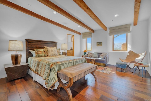 bedroom with beamed ceiling and dark wood-type flooring