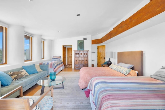 bedroom featuring lofted ceiling and light hardwood / wood-style flooring