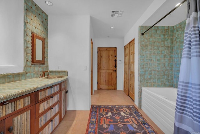 bathroom featuring tile patterned floors, shower / tub combo with curtain, vanity, and tile walls