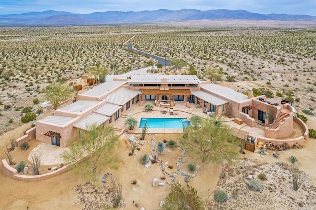 birds eye view of property with a mountain view