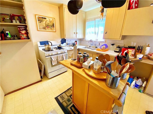 1201 W Verdugo Ave, Burbank, CA 91506 - kitchen featuring wood counters, white cabinets, white range with gas stovetop, and a sink