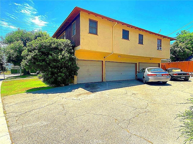 1201 W Verdugo Ave, Burbank, CA 91506 - exterior space featuring stucco siding, fence, aphalt driveway, and a garage