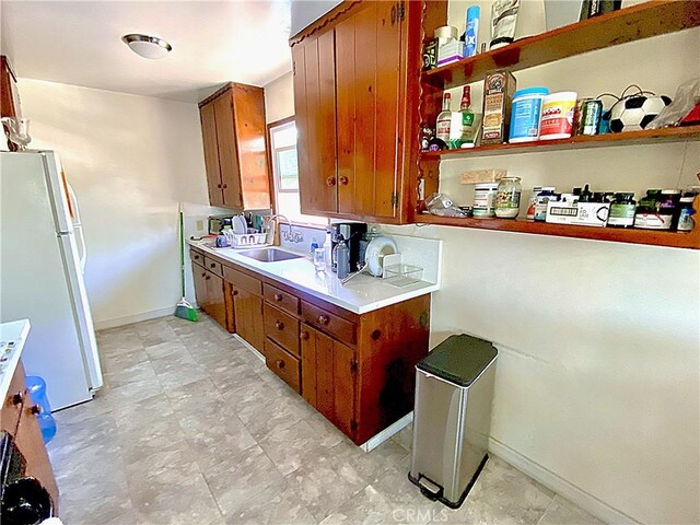 1201 W Verdugo Ave, Burbank, CA 91506 - kitchen with a sink, freestanding refrigerator, open shelves, brown cabinetry, and light countertops