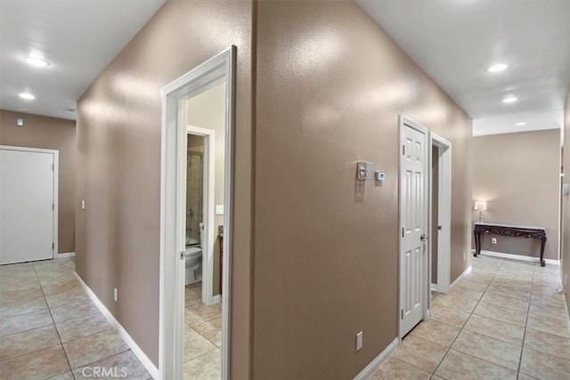 hall with light tile patterned flooring