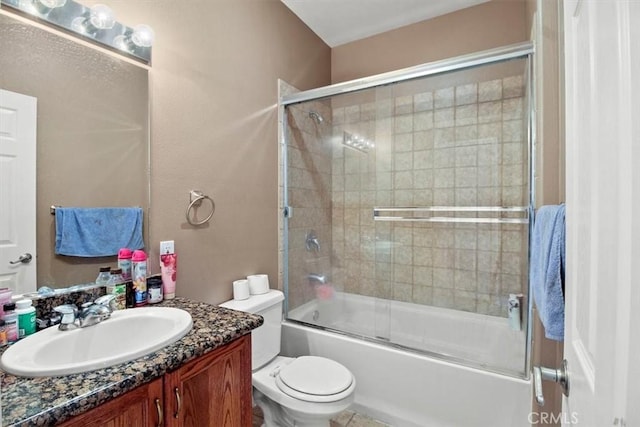 full bathroom with vanity, shower / bath combination with glass door, and toilet