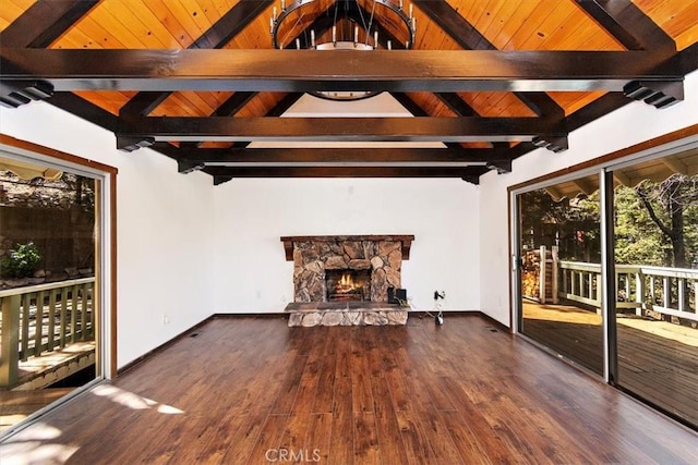 unfurnished living room with dark hardwood / wood-style flooring, a fireplace, and lofted ceiling with beams