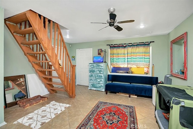 interior space featuring light tile patterned floors and ceiling fan