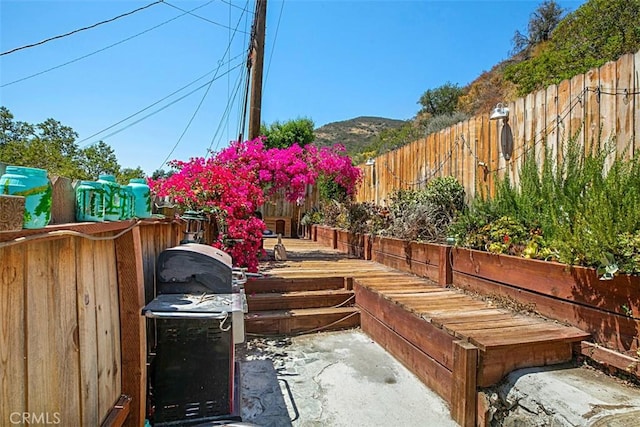 view of patio featuring a mountain view and a grill